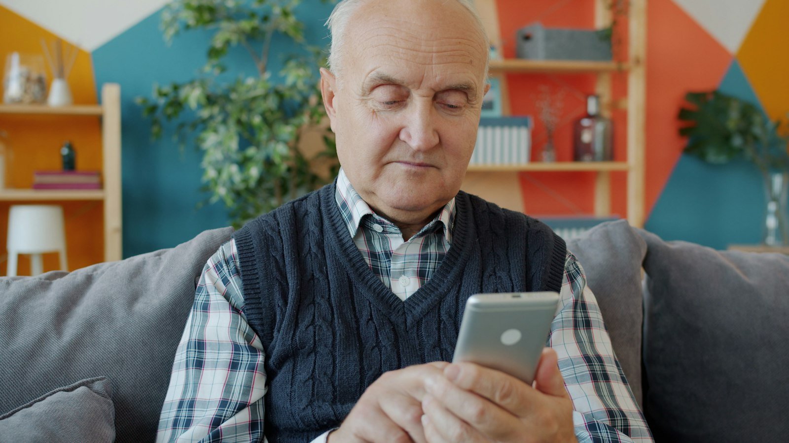 Older homeowner using a phone at home